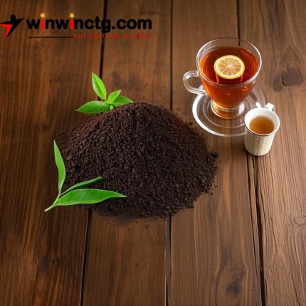 This image appears to depict loose black tea leaves along with a cup of brewed tea on a wooden background.